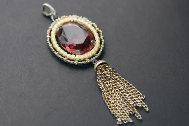 Vintage Avon Amethyst Seed Pearl Tassle Pendant early 60's Lot 1180: Vintage Avon Amethyst Seed Pearl Tassle Pendant early 60's signed measures 1 1/2" just centerpiece measures 3 1/2" with tassle and hook bale