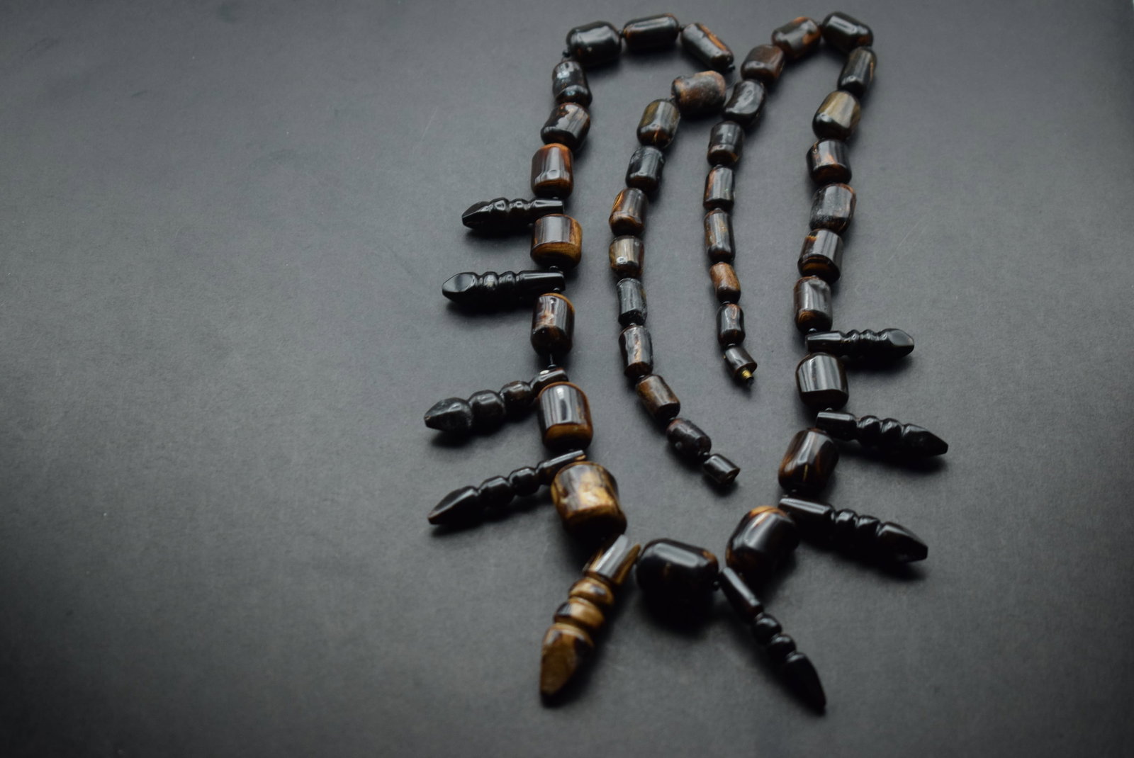 phenominal Wood Necklace Ebony vintage carved Lot 343: phenominal Wood Necklace Ebony vintage carved measures 25 1/2" long drops in the front 1 1/2" has a hidden barrel clasp embedded in the wood for closure very well thought out as opposed to just puttin