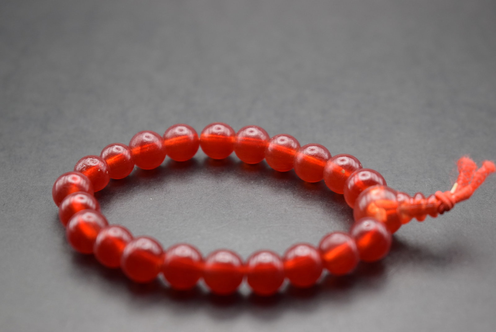 Red Glass Buddist Prayer Bracelet one size Lot 464: Red Glass Buddist Prayer Bracelet one size stretch fits all beads measure 7.75mm