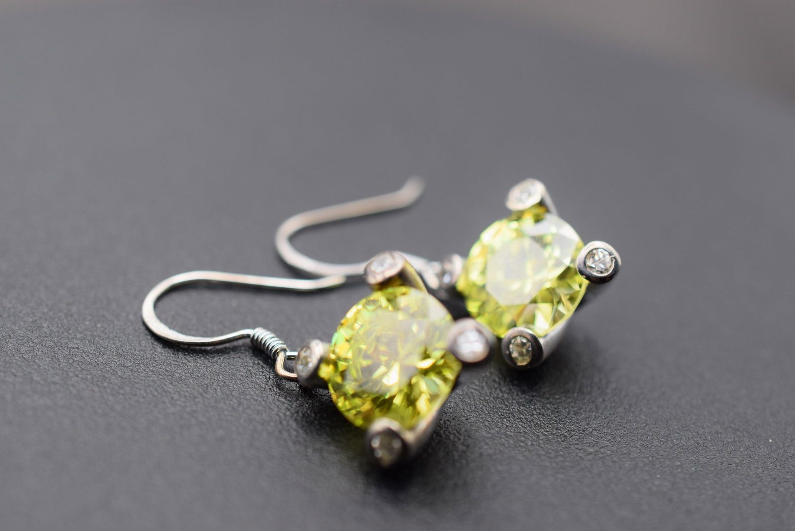Olivine Peridot Sterling Pierced Earrings Lot 992: Olivine Peridot Sterling Pierced Earrings Signed 925 on the flat side of the ear wires 11mm center stone