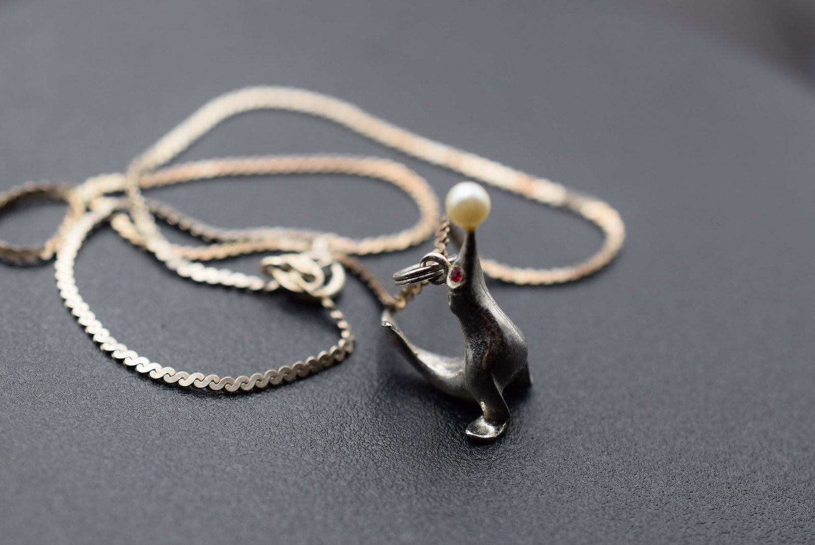 Sterling Silver 925 Seal Pendant Necklace Lot 1138: Sterling Silver 925 Seal Pendant Necklace Seal weighs 6.60 grams measures 1" x 1/2" signed Ster RJL the Chain Measures 15" long and is stamped 925