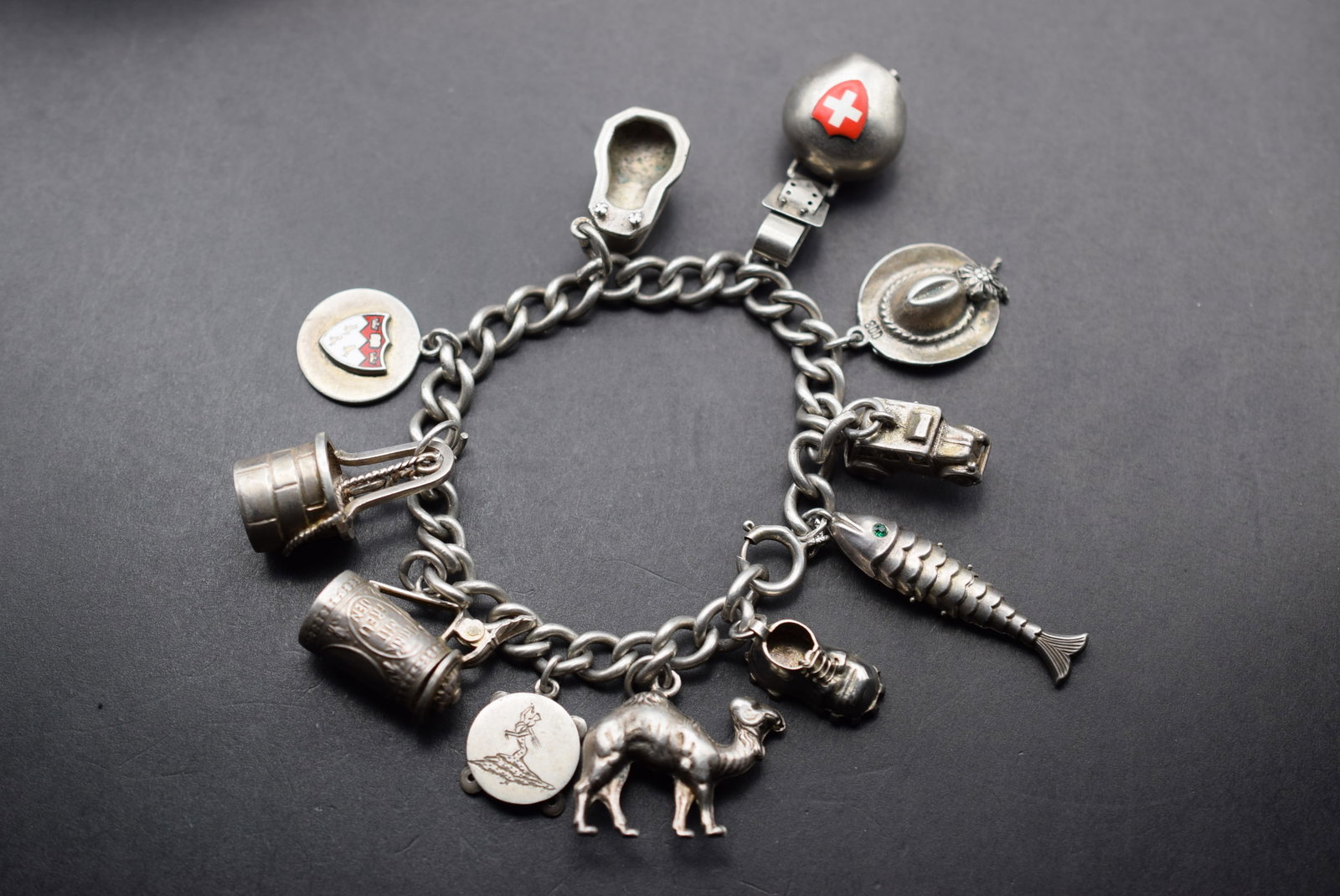 OLD Swiss Sterling Charm Bracelet 11 Charms 48 grams Lot 7: OLD Swiss Sterling Charm Bracelet 11 Charms weighs 48.83 grams Link Bracelet is signed Sterling and the charms are signed Sterling and some are signed 800 and a couple are unsigned very interesting co