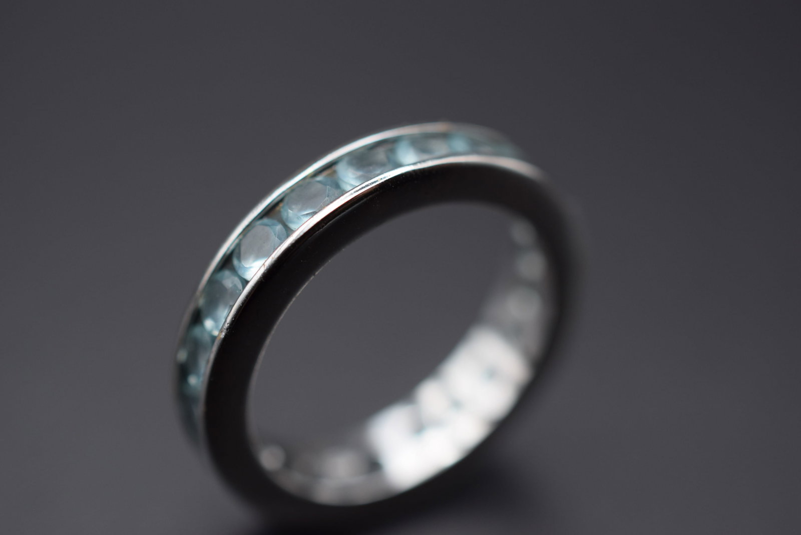 Eternity CZ Aqua Sterling Silver 925 Size 6.75 Lot 136: Eternity CZ Aqua Sterling Silver 925 Size 6.75 weighs 3.20 grams signed inside 925 measures 3/16" wide