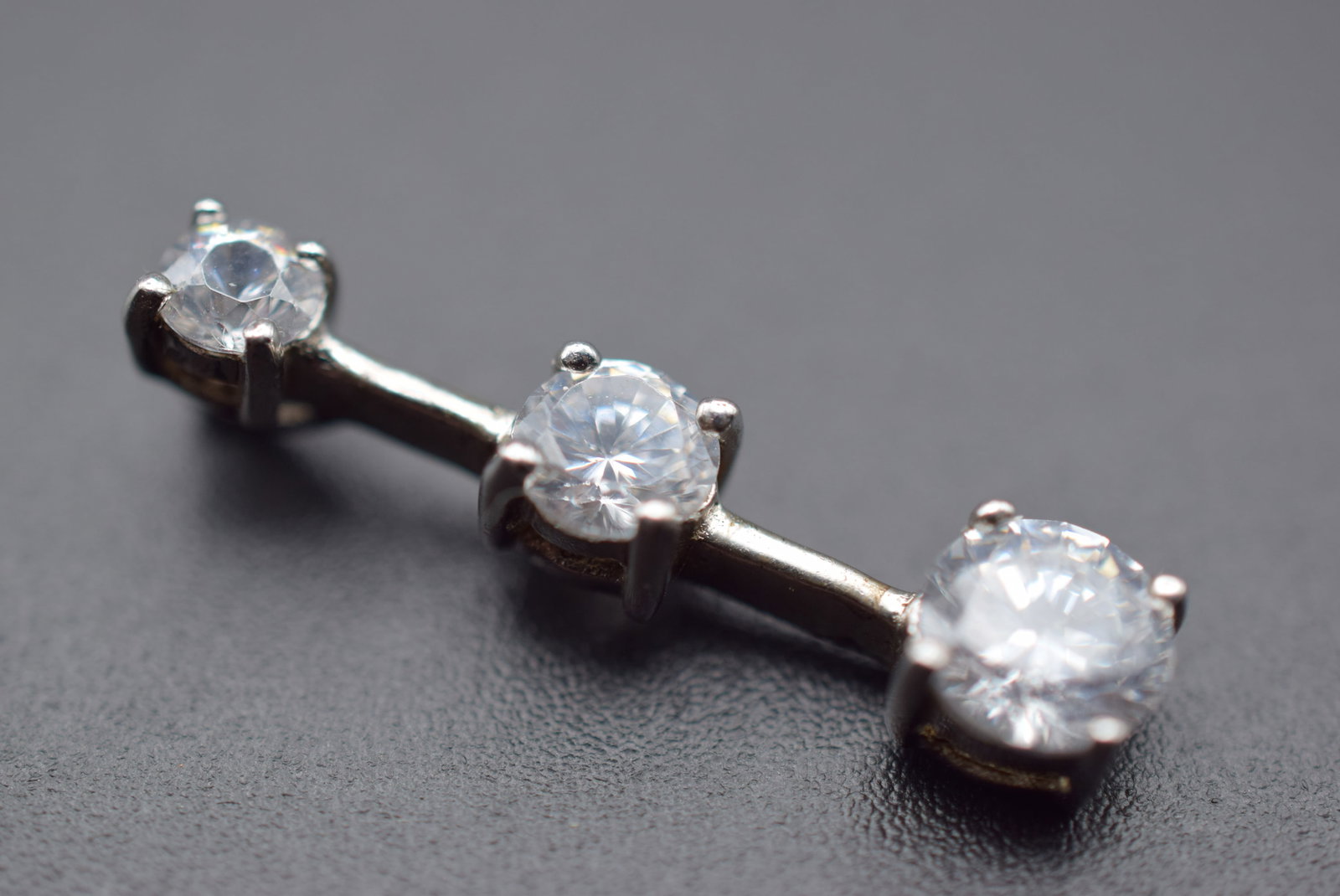 CZ Triple Pendant Sterling Silver 925 Lot 146: CZ Triple Pendant Sterling Silver 925 measures 1" x 1/4" and is signed on the back 925 weighs 1.82 grams