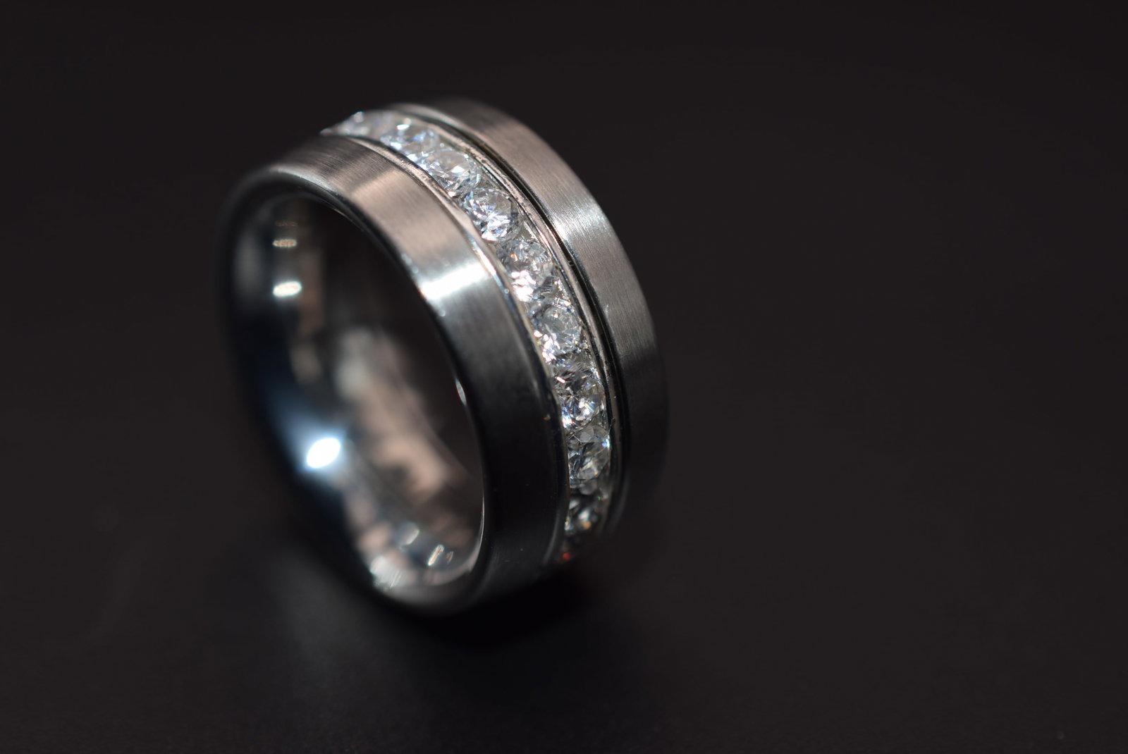 Lumani Stainless Steel CZ Band Ring Size 6 Lot 229: Lumani Stainless Steel CZ Band Ring Size 6 measures 3/8" wide signed Lumani Steel