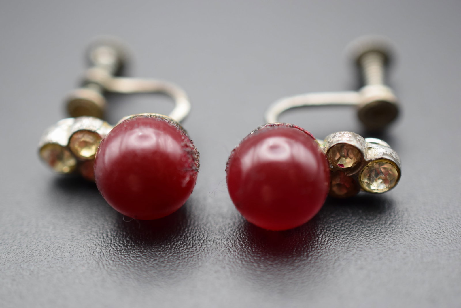 1940's Screwback Red Cat's Eye Vintage Earrings Lot EH 434: 1940's Screwback Red Cat's Eye Vintage Earrings measures 5/8" x 3/8" signed Sterling on the backs around the stone