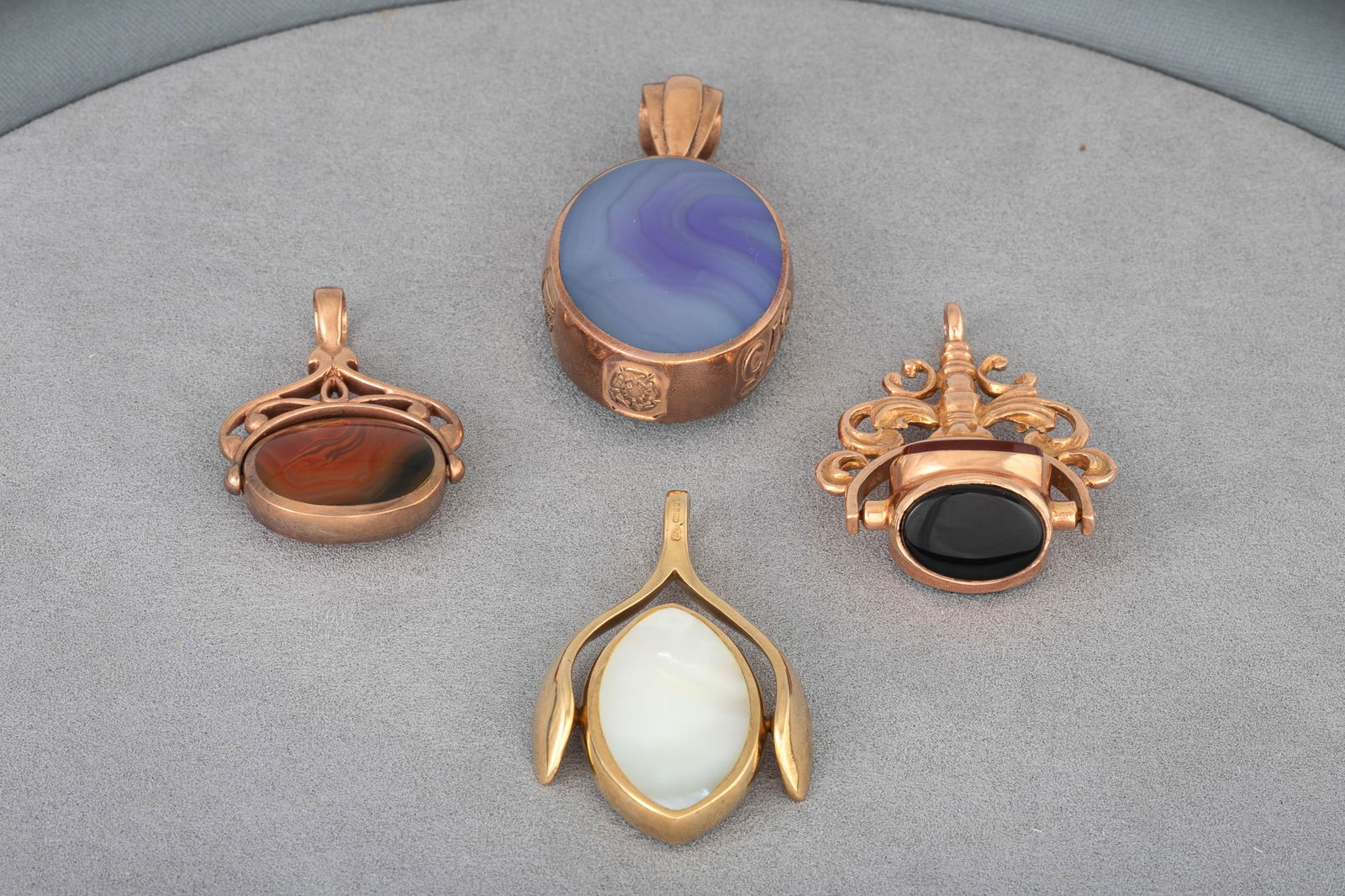 A COLLECTION OF FOUR 9CT GOLD FRAMED FOBS, various stone set, 45.8 g. (1 of 1)