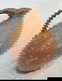 Handled redware ovoid jug.