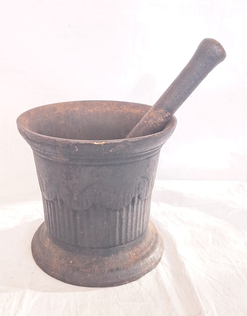 19th Century Cast Iron Mortar and Pestle: Mortar: 6" tall x 6 3/4" wide at top. Pestle: 9 1/2" long.