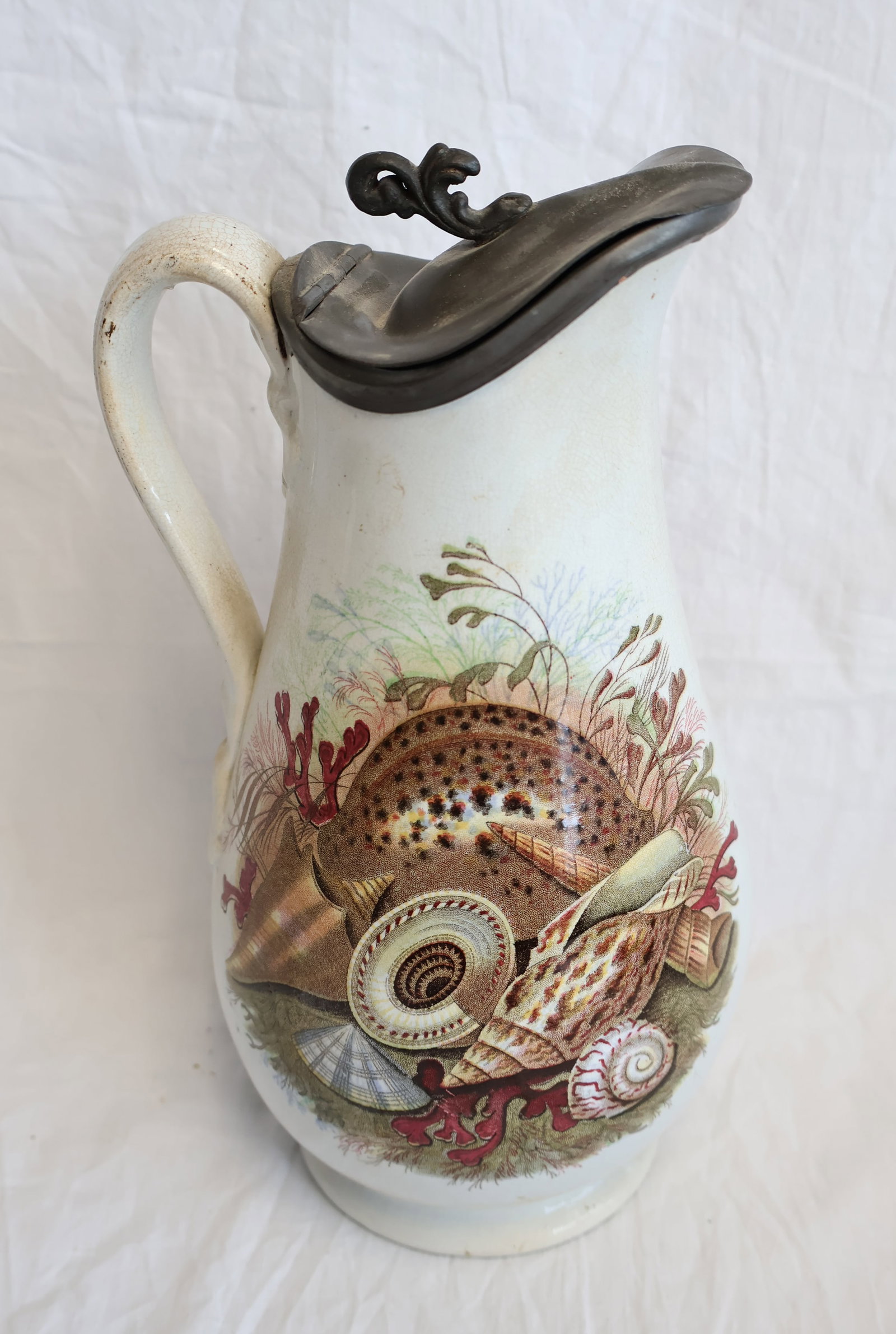 Ironstone Pitcher by M.W. & co. with Seashell Decoration: 10" x 6" with handle. Gurley Auction Company provides In House Packing and Shipping and strive to keep costs as reasonable as possible. Please take the time to research the cost of shipping for the it