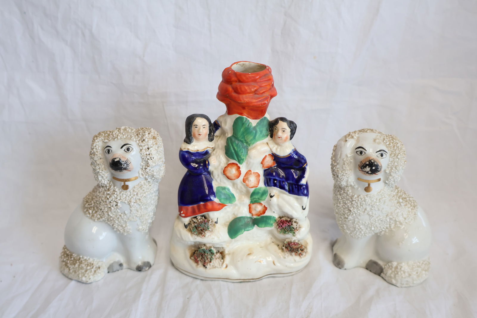 Lot of Three Pieces of Staffordshire including a Vase and a Pair of Dog Figurines: Vase: 5 3/4" x 4 1/2" x 2 3/4" Dogs: 4 1/2" x 3" x 2" Gurley Auction Company provides In House Packing and Shipping and strive to keep costs as reasonable as possible. Please take the time