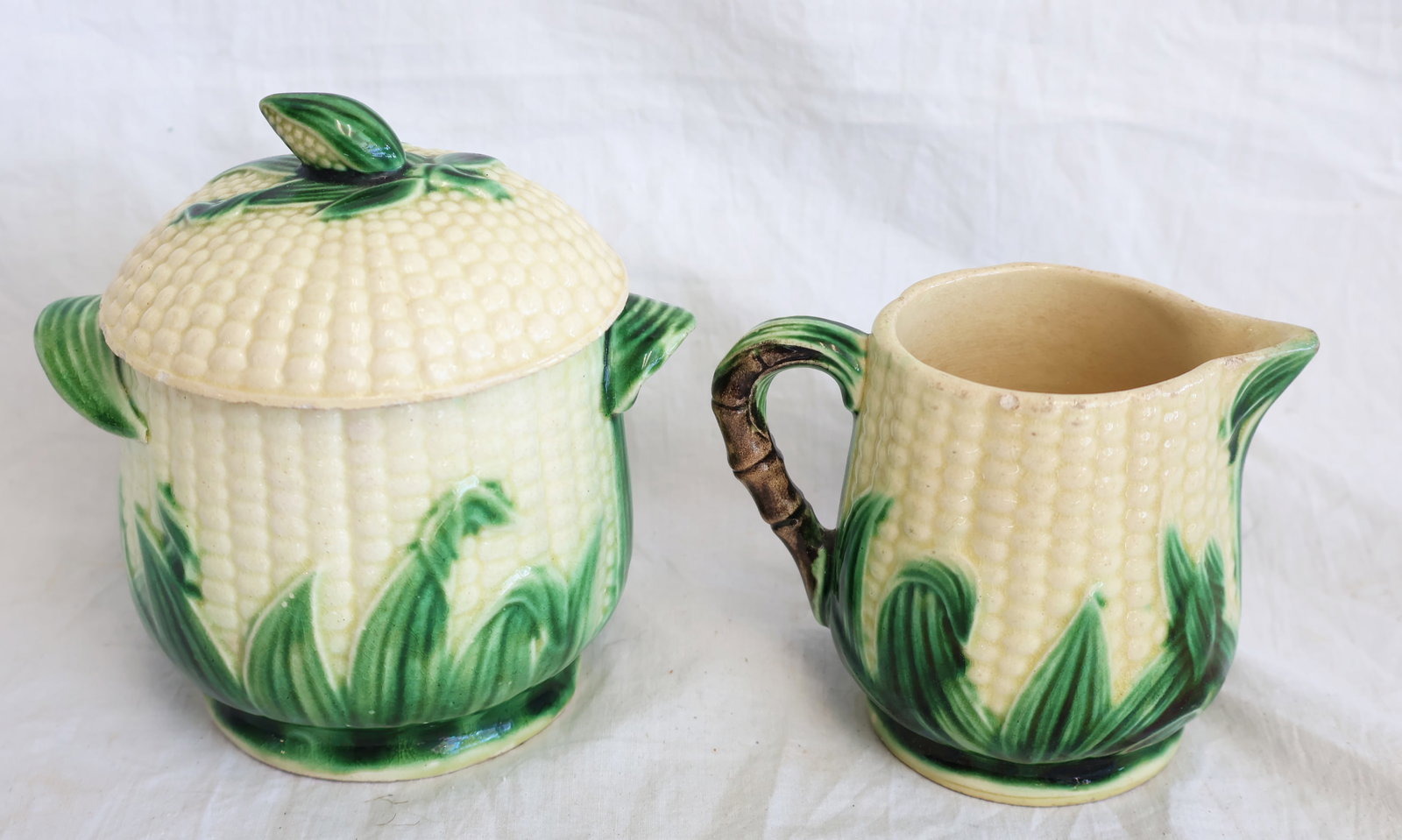 Lot of Two Pieces of Majolica with Corn Motif- Sugar Bowl and Creamer: Creamer: 3 1/4" x 4 1/4" with handle Sugar Bowl: 5" tall x 5 1/2" with handles. Gurley Auction Company provides In House Packing and Shipping and strive to keep costs as reasonable as possible. 