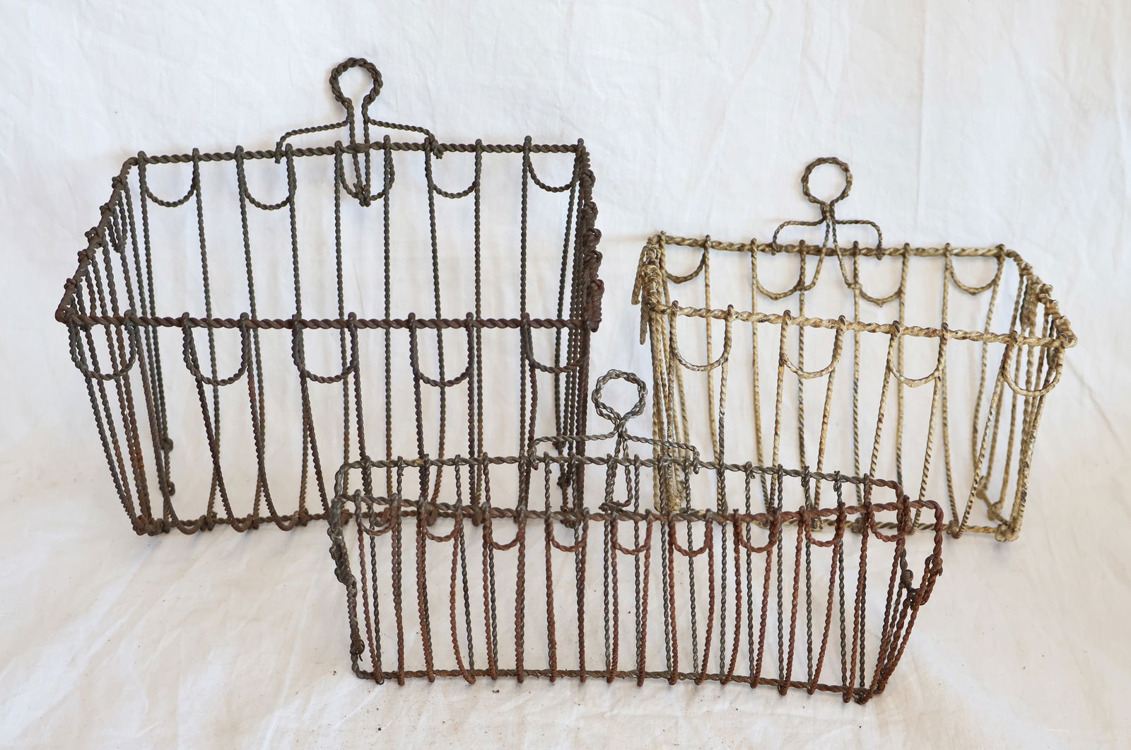 Lot of Three Wire Wall Baskets: Largest: 8 1/4" wide x 8 1/2" tall x 5 1/4" deep Smallest: 9" wide x 5" tall x 3 1/4" deep. Gurley Auction Company provides In House Packing and Shipping and strive to keep costs as reasonable
