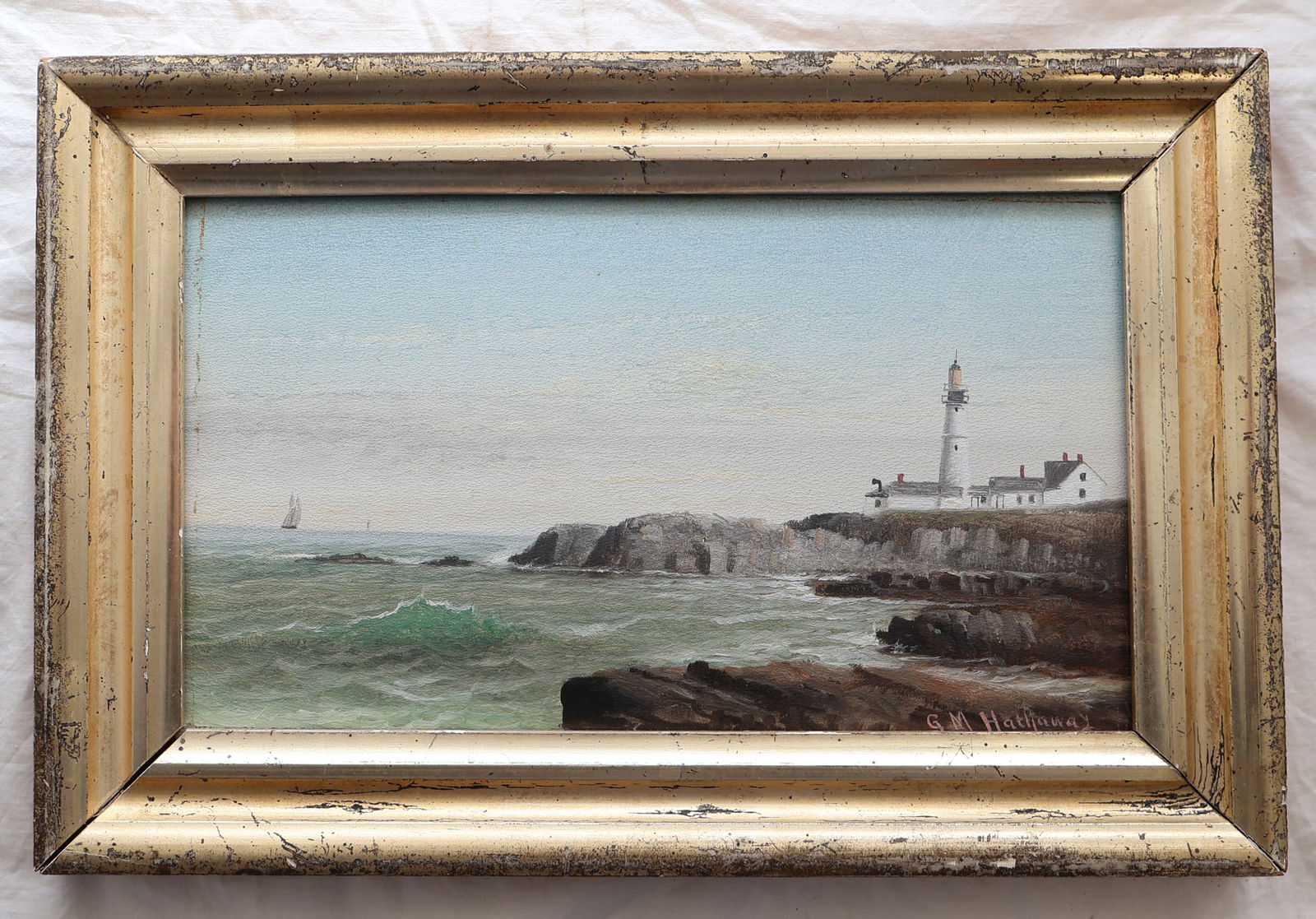 Oil on Board of Lighthouse Signed G.M. Hathaway in Lemon Gold Frame: Frame: 13" x 8 1/2" Sight: 10" x 5 3/4" Gurley Auction Company provides In House Packing and Shipping and strive to keep costs as reasonable as possible. Please take the time to research the cost of s