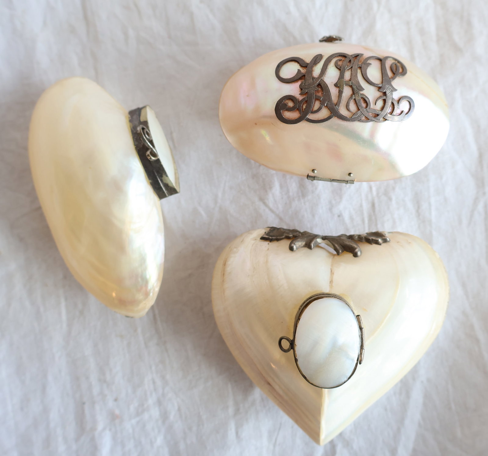 Lot of Three Purses Made from Seashells: Heart shaped:3 1/4" x 2 3/4" x 1 /2" Shell with Applied Initials KAL: 3" x 2" x 1 1/2" Gurley Auction Company provides In House Packing and Shipping and strive to keep costs as reasonable as possible.