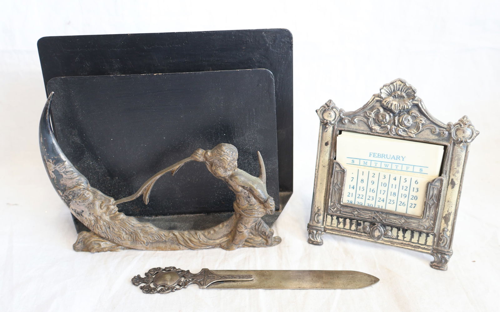 Lot of Three Pieces of Desk Items; Letter Opener, letter Holder with Girl and Moon, & Calendar: Calendar: 4 1/4" 3 1/4" Letter Holder: 6" x 5" x 2 3/4" deep Letter Opener: 5 1/2" x 1/2" Gurley Auction Company provides In House Packing and Shipping and strive to keep costs as reasonable as possib