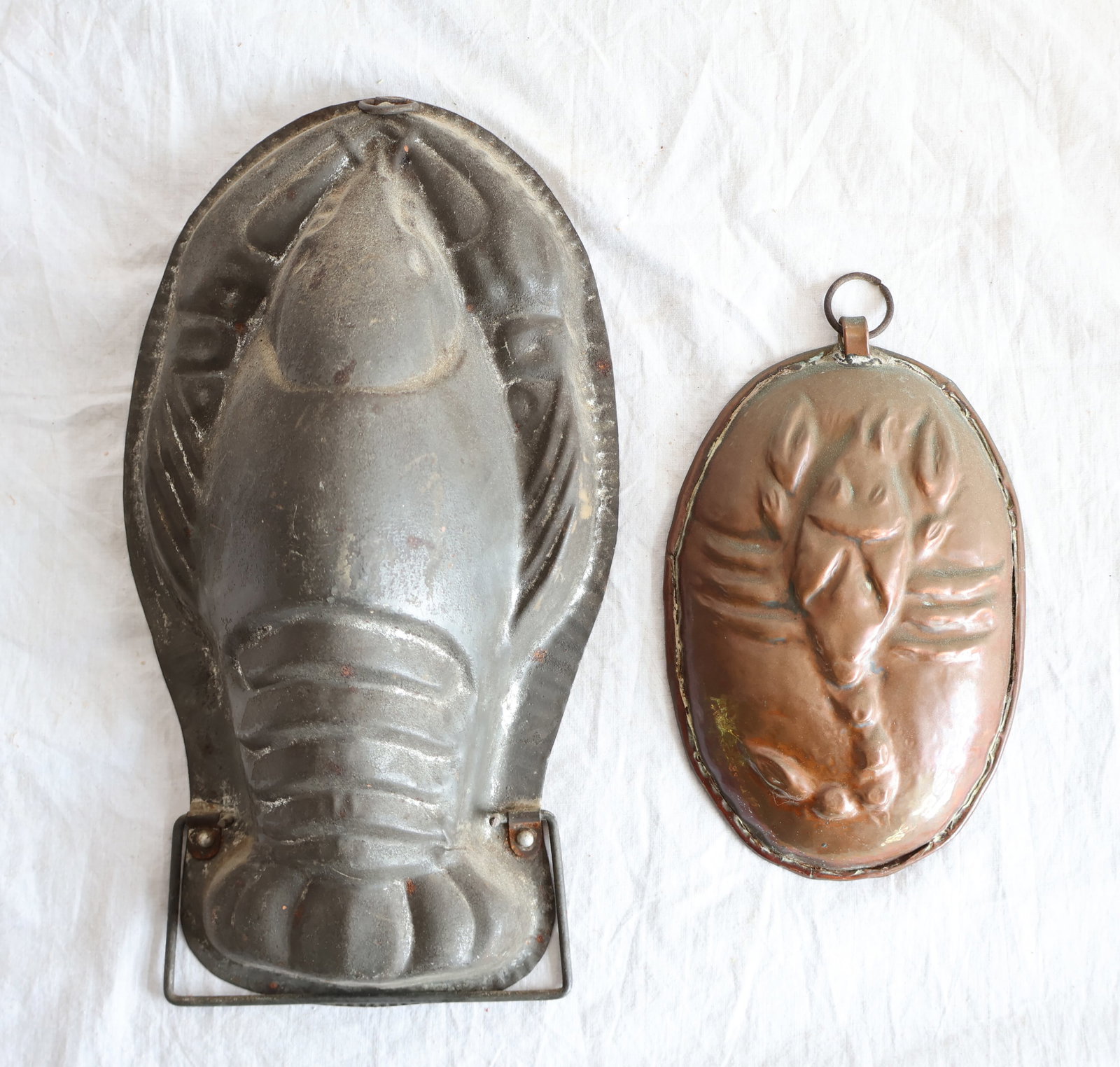 Lot Two Metal Molds Depicting Lobsters; 1 Tin and 1 Copper: Large T1n Mold: 9 3/4" x 5 1/2" x 2 1/2" Small Copper mold: 6 1/4" x 4" Gurley Auction Company provides In House Packing and Shipping and strive to keep costs as reasonable as possible. Please take th