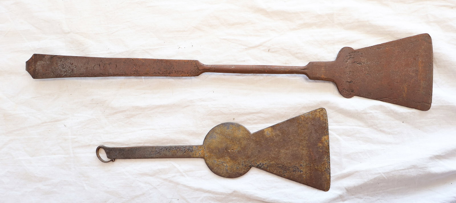 Lot of Two Wrought Iron Spatulas: Keyhole Spatula: 10 1/4" x 3 1/2" Spatula: 18 1/2" x 3 1/4" Gurley Auction Company provides In House Packing and Shipping and strive to keep costs as reasonable as possible. Please take the time to re