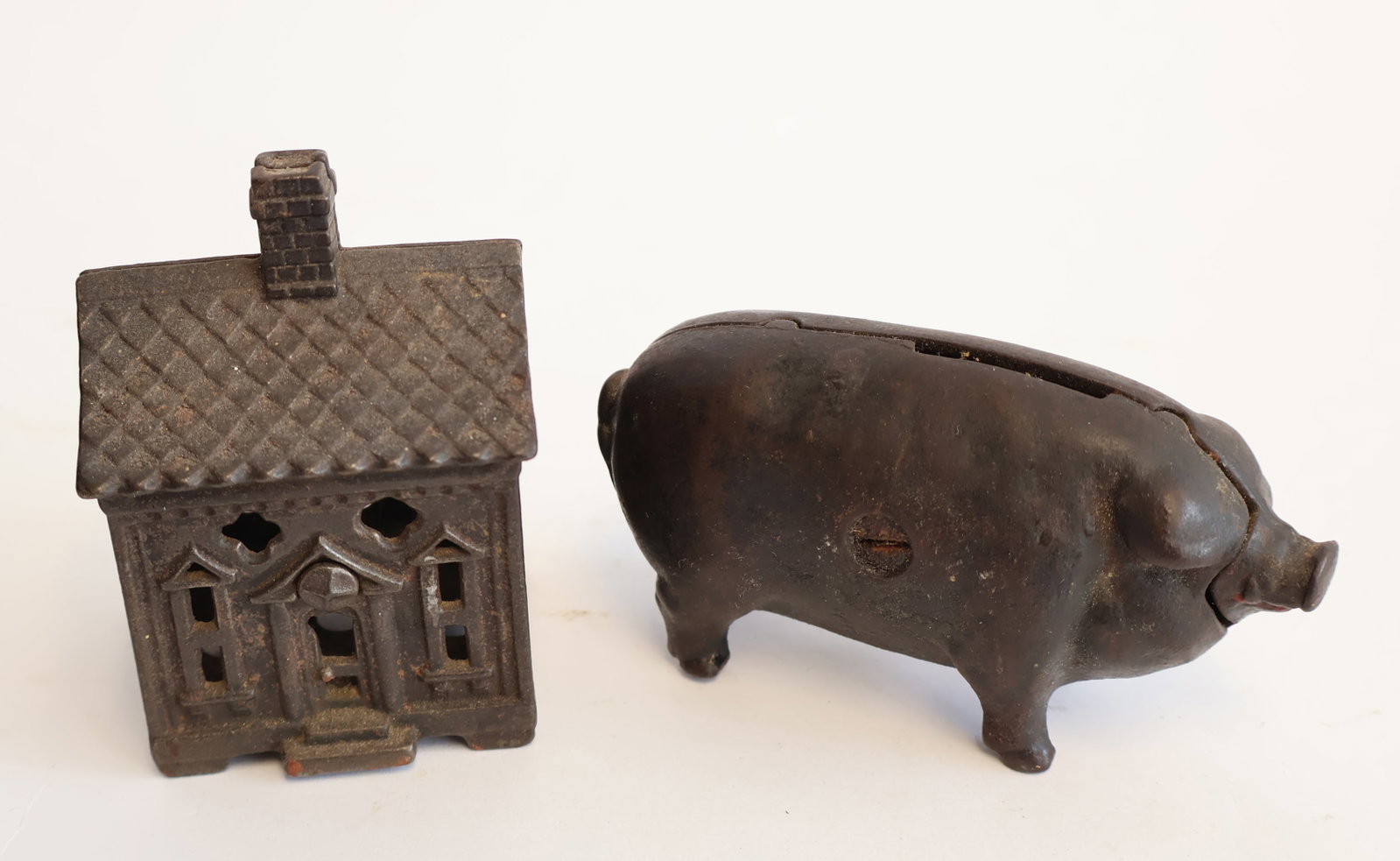 Lot of Two Pieces of Cast Iron: Building: 3 1/4" x 2 1/4" x 2" Pig: 2" x 4 1/2" x 1 1/2" Gurley Auction Company provides IN HOUSE PACKING AND SHIPPING and we strive to keep costs as reasonable as possible. Please take the time to