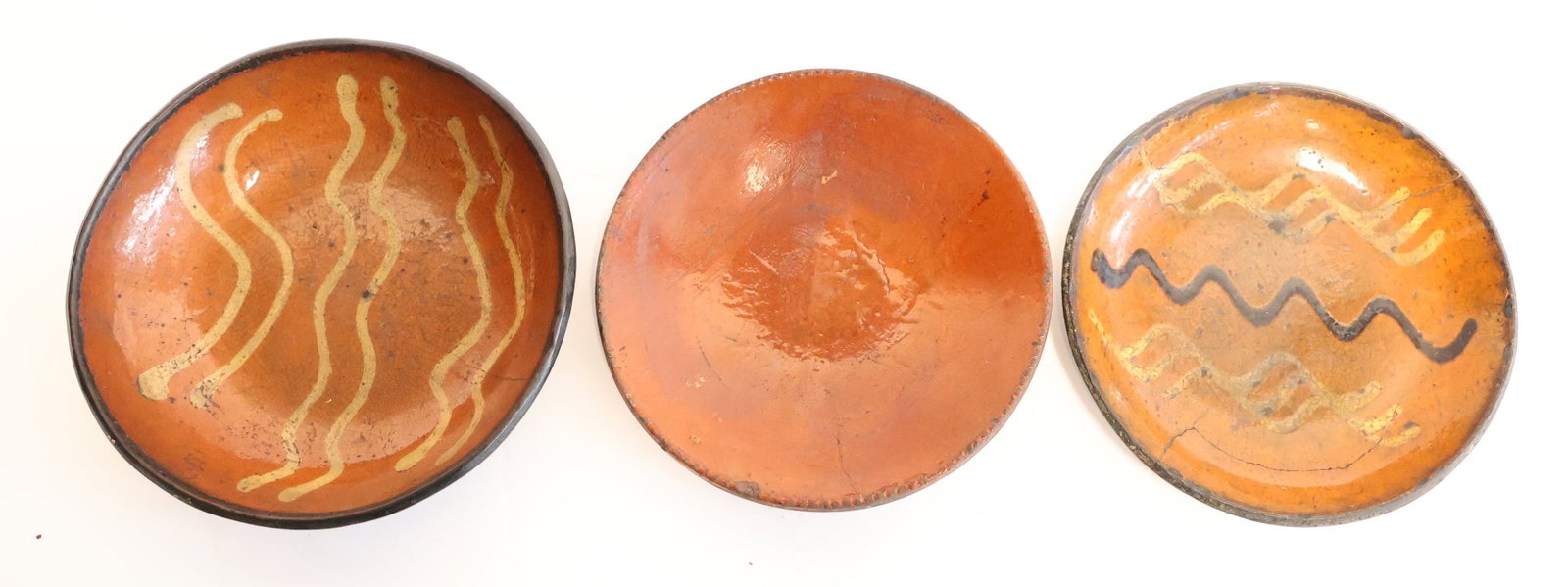 Lot of Three Redware Plates: Possibly from Pennsylvania> 7" t 7 3/4" wide Gurley Auction Company provides IN HOUSE PACKING AND SHIPPING and we strive to keep costs as reasonable as possible. Please take the time to research the