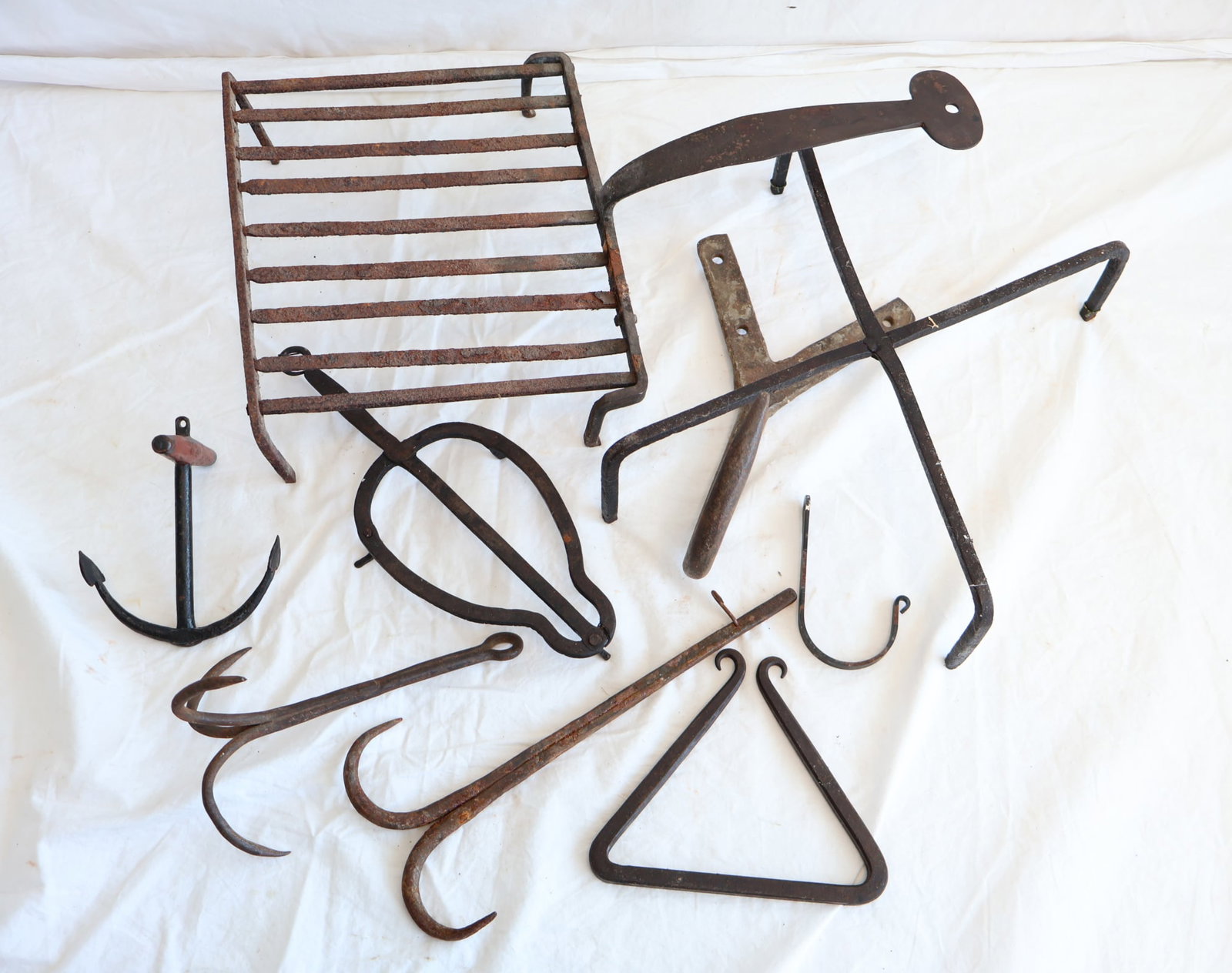 Lot of Wrought Iron Hooks, Trivets, and Toaster: Gurley Auction Company provides IN HOUSE PACKING AND SHIPPING and we strive to keep costs as reasonable as possible. Please take the time to research the cost of shipping for the items that you are in