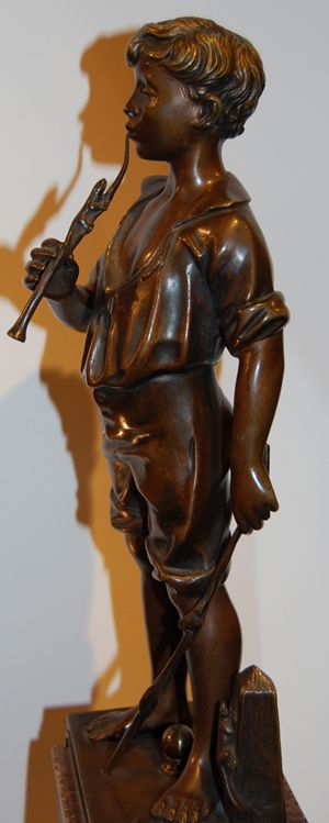 A statues of a boy playing the flute "Charmeur d: A statues of a boy playing the flute "Charmeur de Lezards per Lavergne" by Adolphe Jean Lavergne; Medium: bronze; size: 17,5"h x 4"d x 5"w;