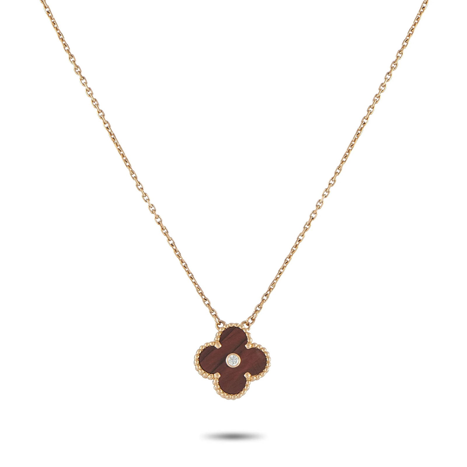 Van Cleef & ArpelsVan Cleef & Arpels Alhambra 18K Rose Gold Diamond and Bulls Eye Holiday Pendant: Effortless to wear and instantly recognizable, this Van Cleef & Arpels necklace stands as the perfect example of refined simplicity. It features the classic Alhambra four-leaf-clover motif as its pend