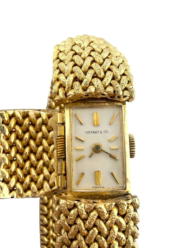 Tiffany & Co. - Bracelet - 14 kt. Yellow gold, Vintage Tiffany & Co. 14K Gold Woven Bracelet Watch: Vintage Tiffany & Co. 14K Gold Woven Bracelet Watch 60 Grams An elegant creation by Tiffany & Co., this exquisite 14K gold bracelet features a finely woven design that seamlessly integrates a hinged w
