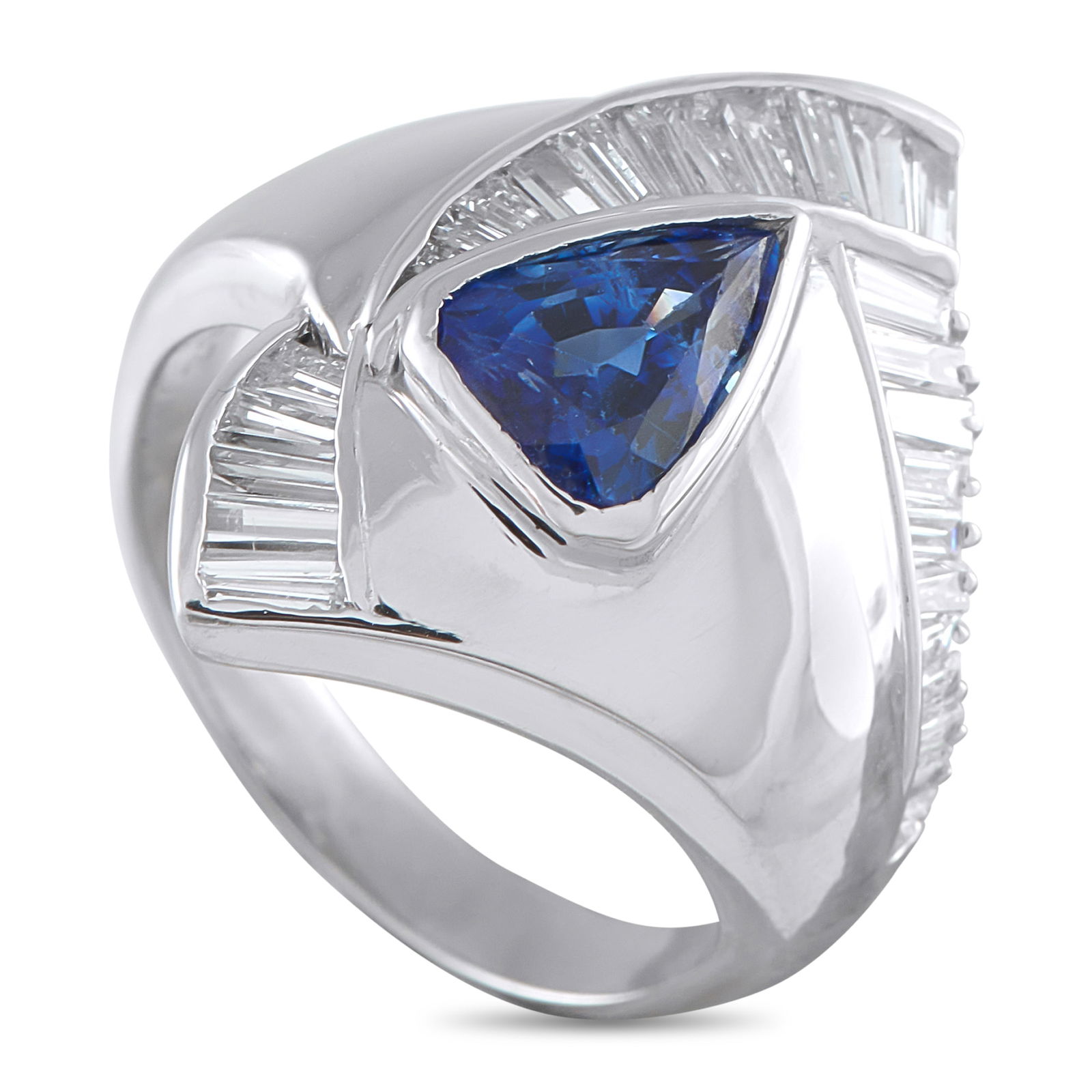 Exclusive Platinum 1.18ct Diamond and Sapphire Statement Ring: The bold contours and sculptural character of this ring instantly capture the eye. At its center lies a trillion-cut blue sapphire, set deep within a platinum frame that emphasizes the blue stone’s