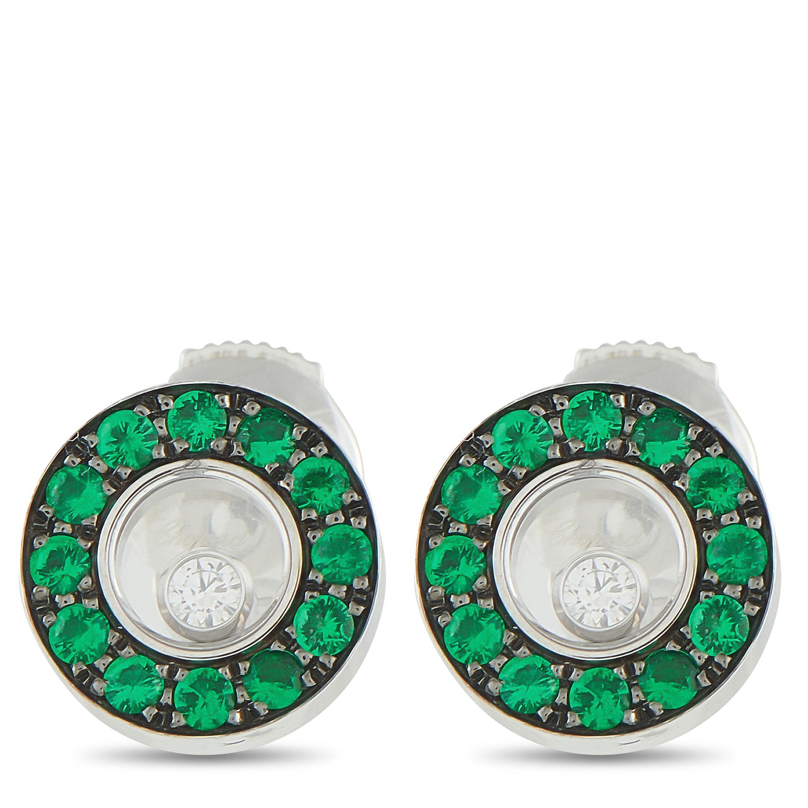 Chopard Happy Diamonds 18K White Gold Diamond and Emerald Stud Earrings: Crafted in gleaming 18K white gold, these Chopard earrings offer a beautiful contrast of dark color, vivid green, and perpetual sparkle. The design centers on a single bezel-set round diamond, set wit