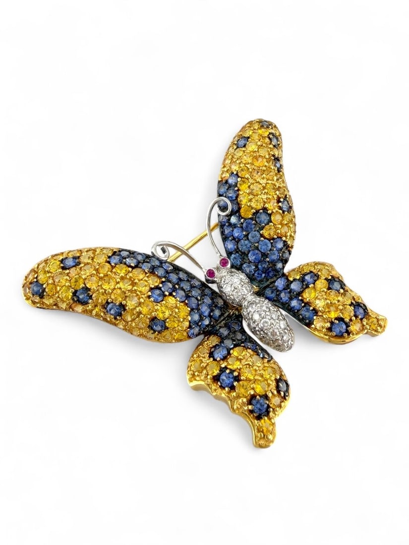 Brooch - 18 kt. Yellow gold, 18K Yellow Gold Multi-Color Sapphire, Diamond, and Ruby Butterfly: 18K Yellow Gold Multi-Color Sapphire, Diamond, and Ruby Butterfly BroochA breathtaking display of color and craftsmanship, this exquisite butterfly brooch is brought to life in 18K yellow gold, adorne