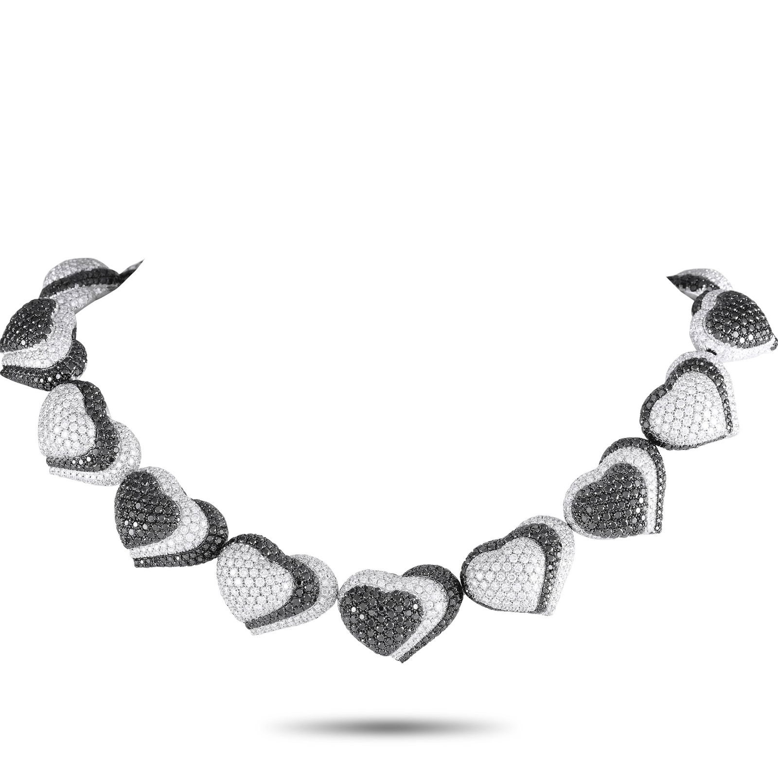 de Grisogono 18K White Gold 57.56ct Diamond Black and White Hearts Necklace: Here is a daring creation of Swiss luxury jeweler De Grisogono showcasing their expertise in using black diamonds. This statement-making necklace features a 15.5-inch-long line of domed hearts, each m