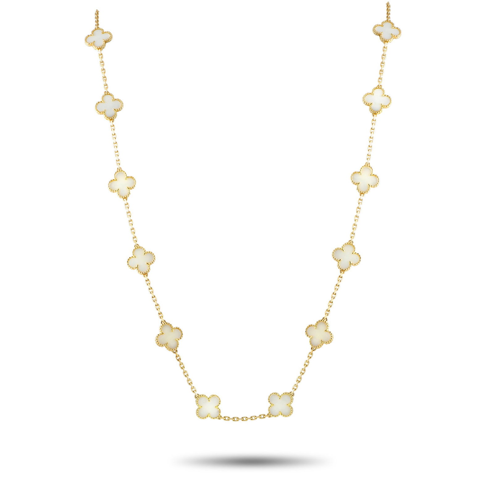 Van Cleef & Arpels Vintage Alhambra 18K Yellow Gold White Coral 20-Motif Necklace: From the Alhambra Collection, this vintage necklace gathers twenty Alhambra motifs, set along a 32-inch-long yellow gold chain. The beaded Alhambra motifs, shaped like a four-leaf clover, feature a wh