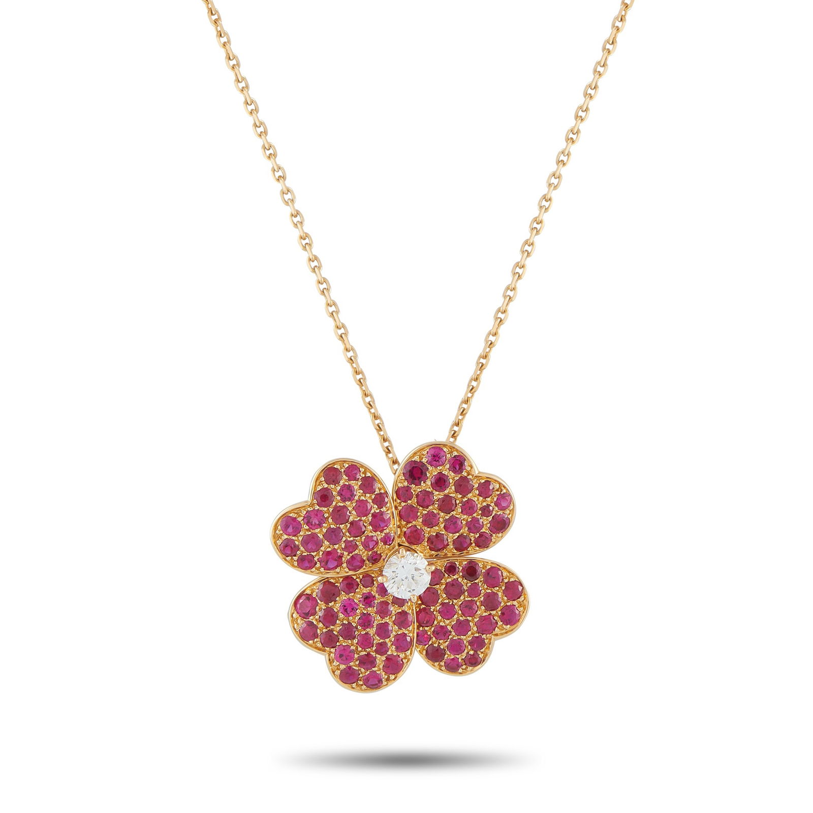 Van Cleef & Arpels Cosmos 18K Yellow Gold Diamond and Ruby Large Model Brooch: A classic floral motif featuring four heart-shaped petals makes this Van Cleef & Arpels Cosmos necklace an iconic luxury piece. A design that originally dates from the 1950s, the flower pendant comes