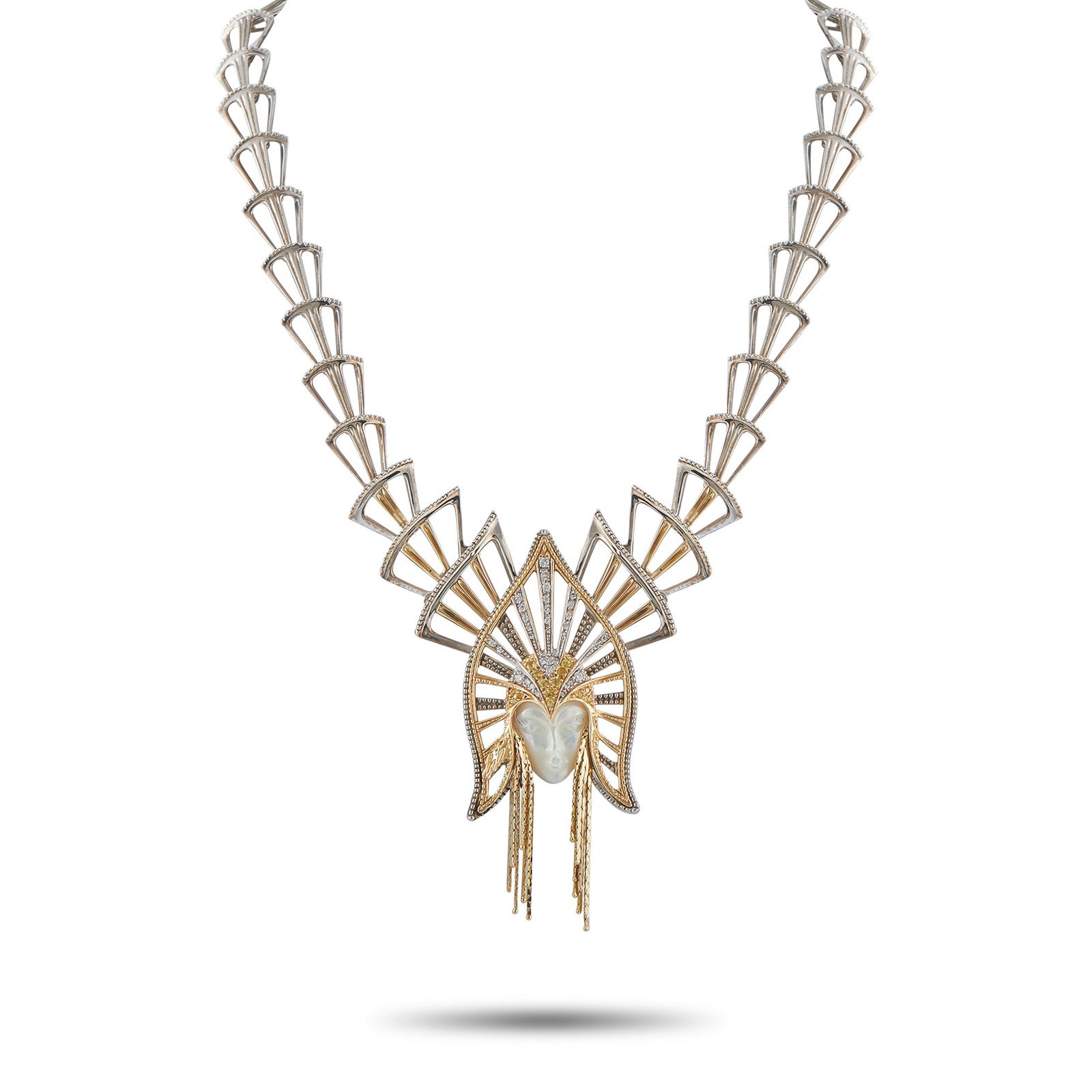 Erte14K Yellow Gold, Silver Mother of Pearl Necklace: A regal female figure makes a statement at the center of this Erte necklace. The woman’s face is crafted from Mother of Pearl – but it’s her glistening, gemstone encrusted headdress that makes t