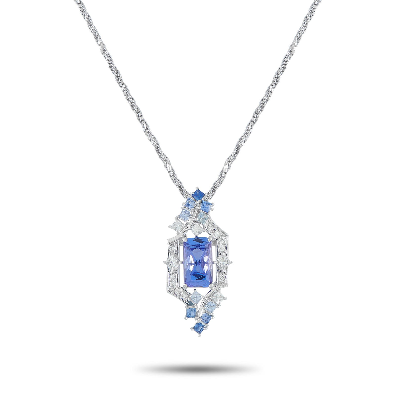 Exclusive Platinum 0.48ct Diamond and Tanzanite Pendant: The design of this Exclusive necklace is a tapestry of form and texture. It starts with a meticulously twisted chain, where the structured precision of box links seamlessly meets the supple flow of a