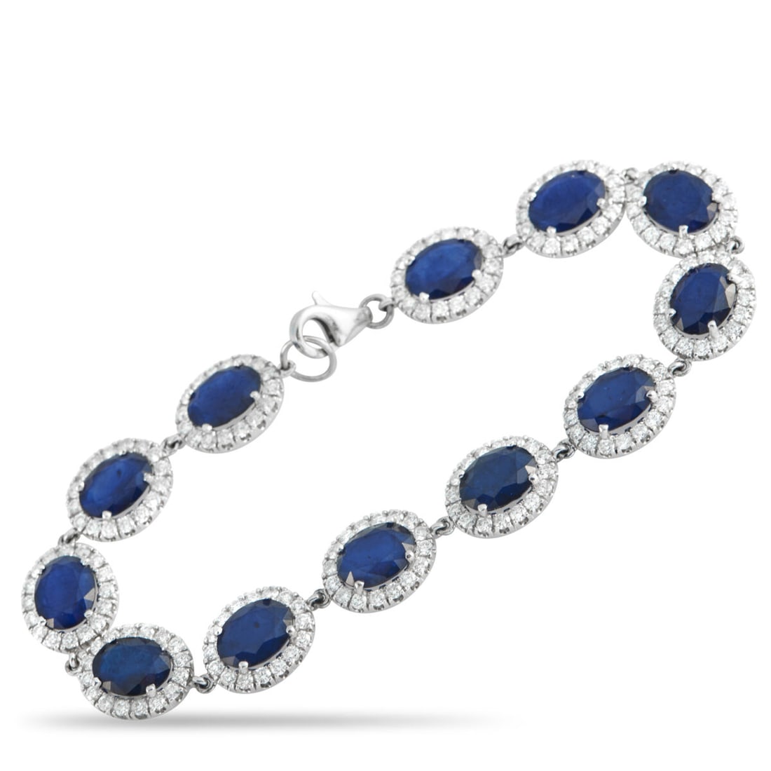 18K White Gold 4.92ct Diamond and Sapphire Bracelet: 18K White Gold 4.92ct Diamond and Sapphire Bracelet. . The white gold bracelet is composed of oval sapphires totaling 24.23 carats. . Each blue stone is held in four prongs and framed by a precise hal