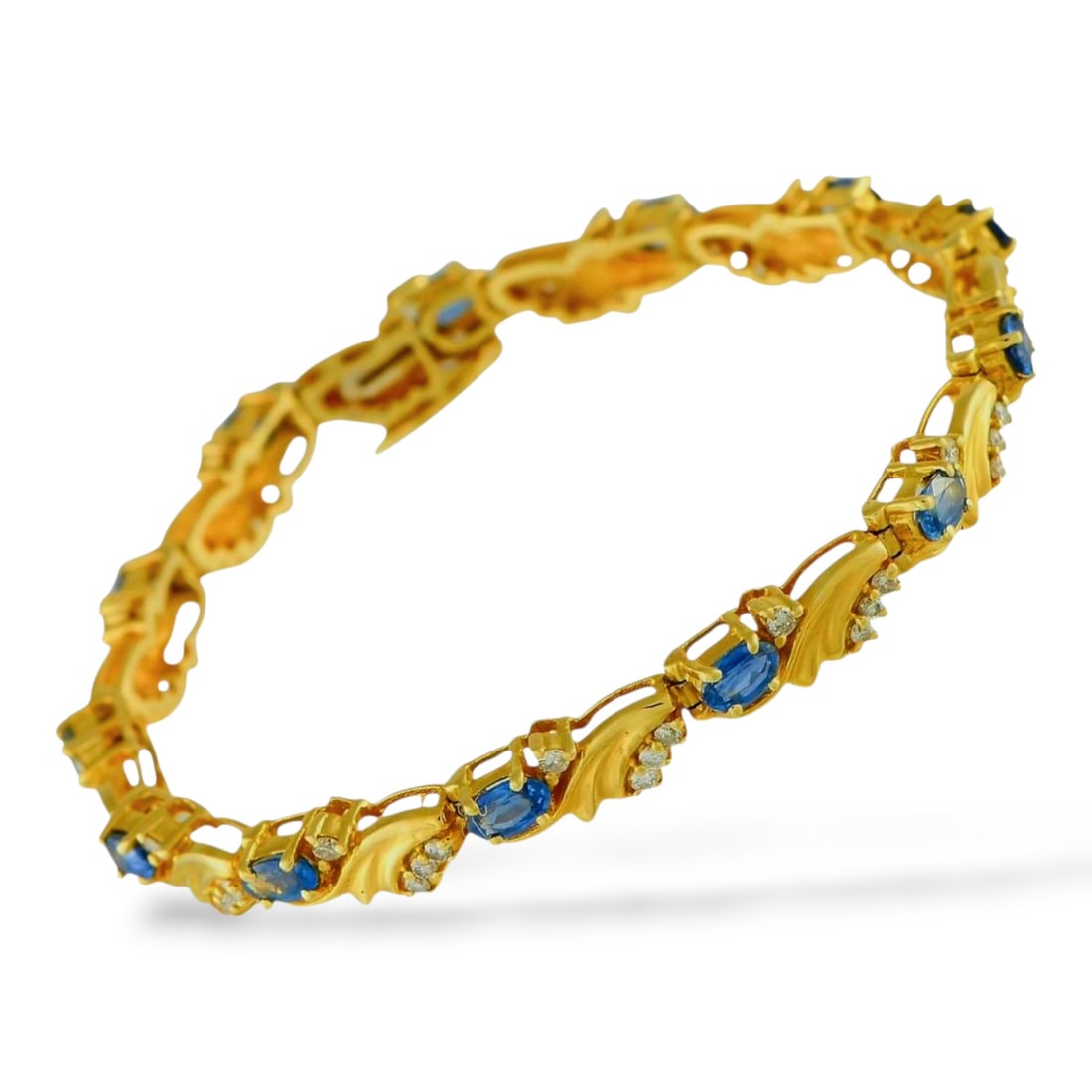 14K Yellow Gold 1.01ct Diamond and 4.0ct Sapphire Bracelet: 14K Yellow Gold 1.01ct Diamond and 4.0ct Sapphire Bracelet A classically elegant design makes this bracelet simply unforgettable. The detailed 14K Yellow Gold setting showcases a series of oval-cut Sa