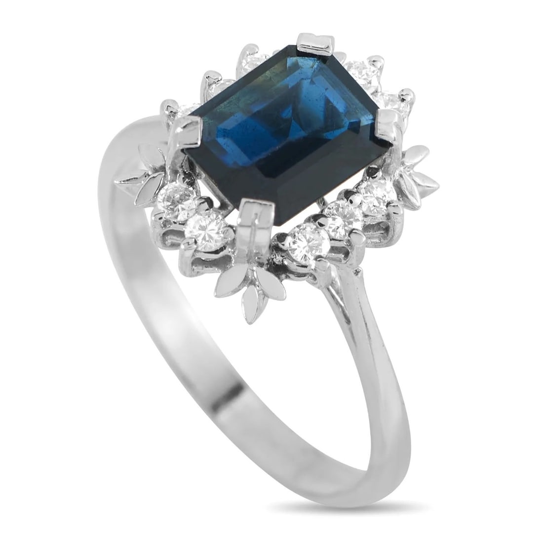 18K White Gold 0.20ct Diamond and Sapphire Ring: 18K White Gold 0.20ct Diamond and Sapphire Ring At the center of the ornate 18K White Gold setting, a 1.45 carat Sapphire serves as a stunning focal point. Diamonds with a total weight of 0.20 carats
