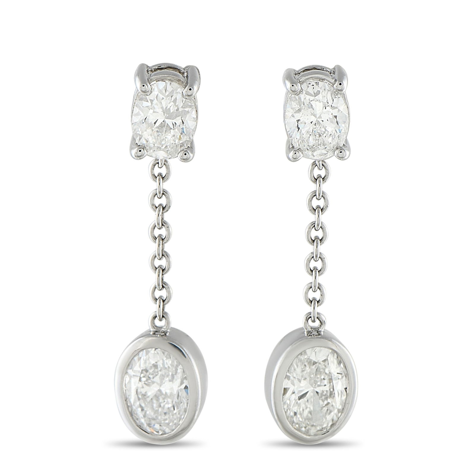 18K White Gold 2.50ct Oval Diamond Dangle Earrings: Shining with every step, the gentle sway of these dangles reflects light from every angle, scattering light in a way no stud can match. An oval diamond in four prongs anchors the post. From it hangs a