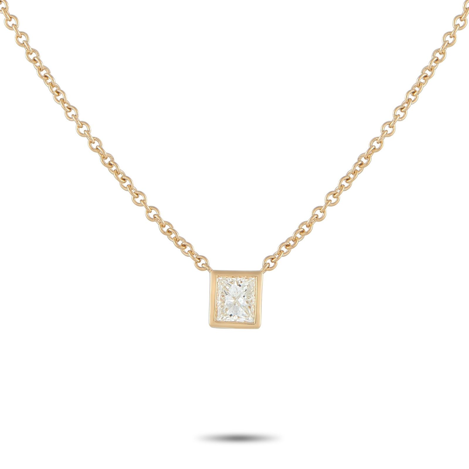 18K Yellow Gold 0.60ct Princess-Cut Diamond Solitaire Necklace: A simple and refined piece perfect for daily wear. A sharp, square princess-cut diamond takes center stage, its facets catching light with crisp, geometric brilliance. It is held securely by a smooth