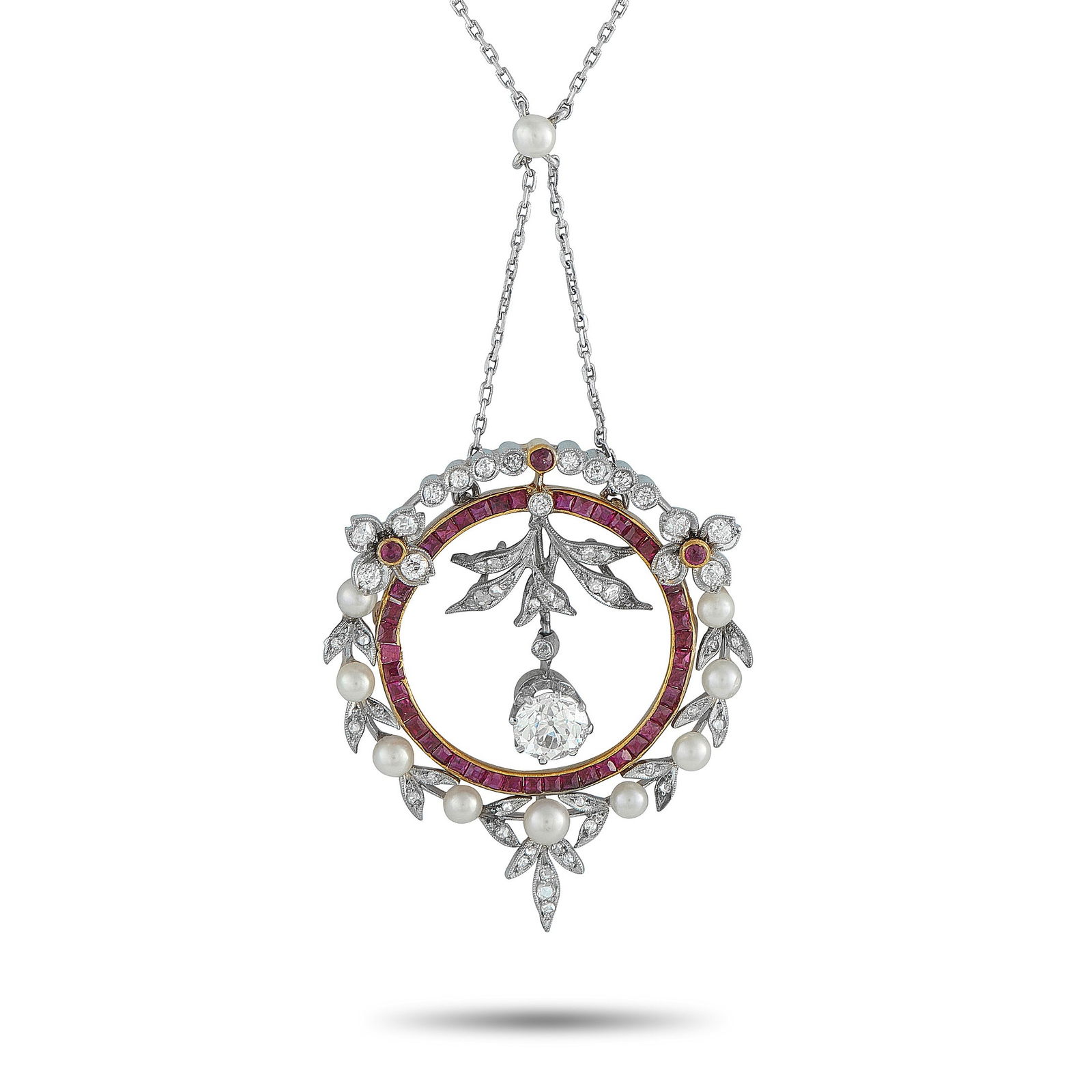 Platinum and 18K Yellow Gold 1.95ct Diamond and Ruby Pendant: This luxury necklace is filled with intricate details. A 1.20 carat Diamond dangles in the center of the circular pendant, while additional Diamonds totaling 0.75 carats effortlessly catch the light.