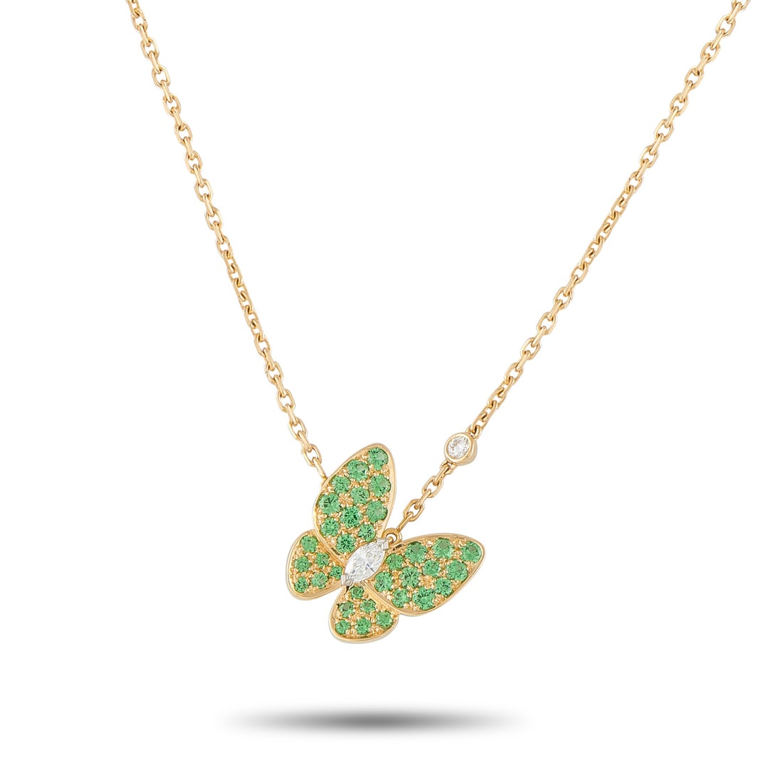 Van Cleef & Arpels Two Butterfly 18K Yellow Gold Diamond and Sapphire Necklace: An asymmetrical design makes this Van Cleef & Arpels Two Butterfly necklace resemble a graceful butterfly in flight. Inset Sapphires add a splash of color to this charming piece. A marquise Diamond at