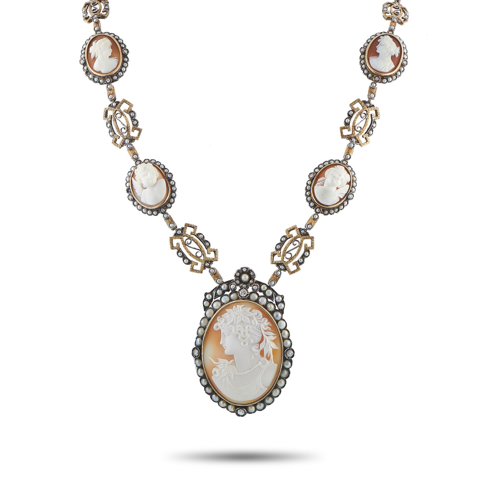Antique 14K White Gold and Silver 2.0ct Diamond Cameo Necklace: This antique cameo necklace is filled with exquisite details. Pearlescent accents and Diamonds totaling 2.0 carats provide this piece with a distinct sense of old fashioned elegance. Crafted from a co