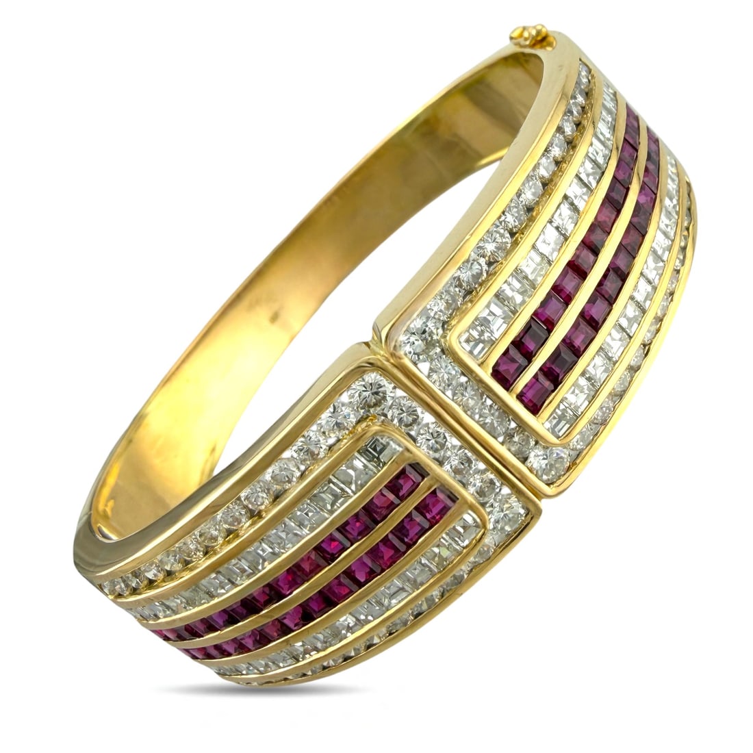 Exclusive 18K Yellow Gold 5.20ct Ruby and 7.02ct Diamond Hinged Bracelet: Exclusive 18K Yellow Gold 5.20ct Ruby and 7.02ct Diamond Hinged Bracelet This stunning bracelet features a sophisticated and symmetrical design set in 18K yellow gold. The hinged band opens to reveal