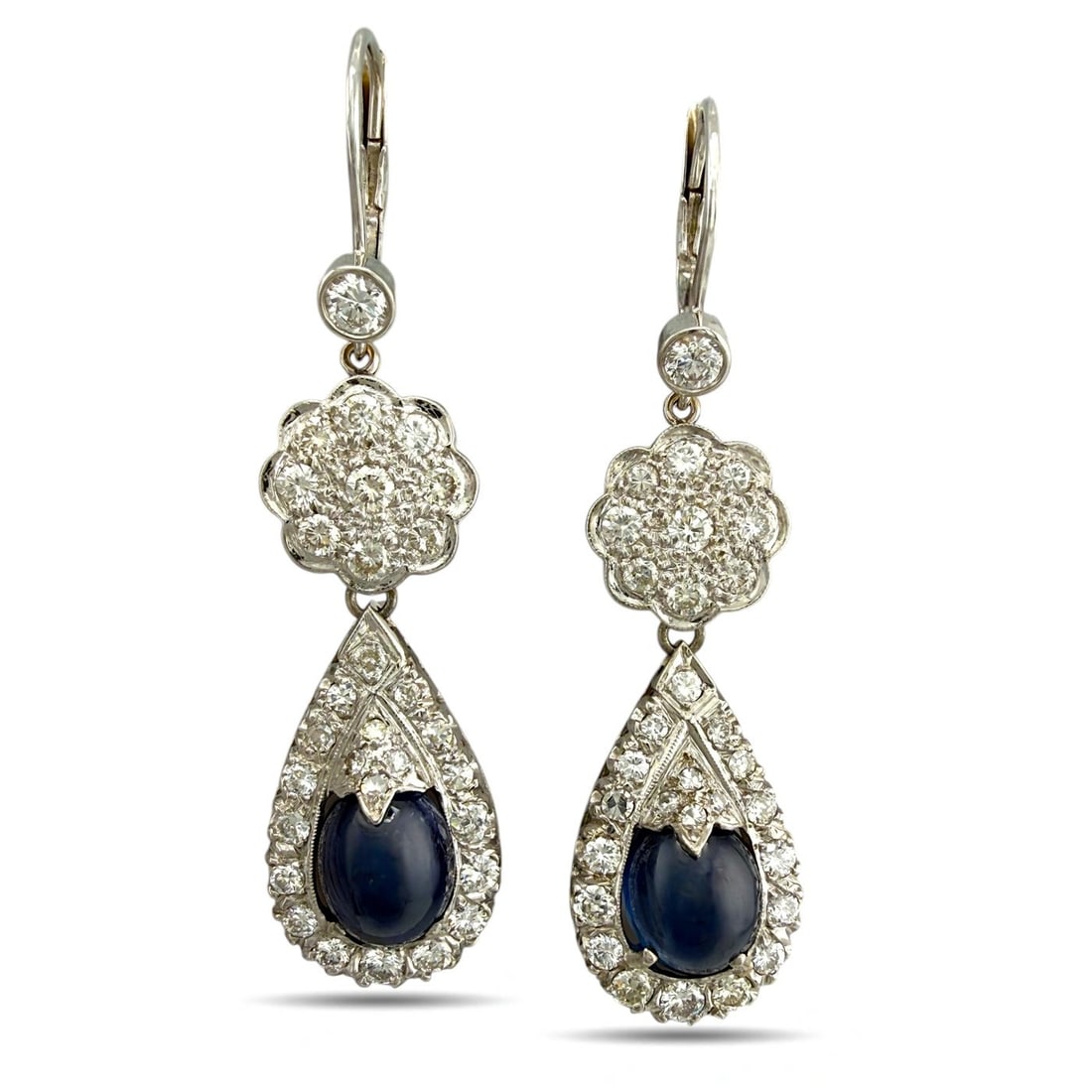 14 kt. Exclusive 14K White Gold 7.00ct Sapphire and 2.36ct Diamond Drop Earrings, White gold -: Exclusive 14K White Gold 7.00ct Sapphire and 2.36ct Diamond Drop EarringsThese elegant drop earrings are crafted in 14K white gold and feature oval cabochon sapphires at the center of each earring, fr