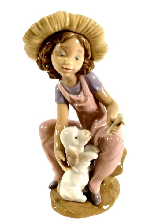 LLADRO FRIENDS FOREVER 1999 PORCELAIN FIGURINE 6680G: LLADRO FRIENDS FOREVER 1999 PORCELAIN FIGURINE 6680GLladro porcelain figurine titled “Friends Forever” (#6680), featuring a young girl in pink overalls and a hat seated with a rabbit on a rock