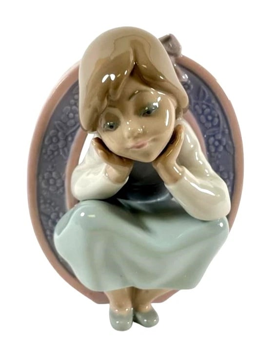 Lladro Schoolgirl O 5148 Porcelain Figurine: Lladro Vintage Limited Edition Schoolgirl O 5148Lladro porcelain figurine titled Schoolgirl O (No. 5148), designed in pastel colors with a girl seated within an ornate O-shaped frame. Measures approxi