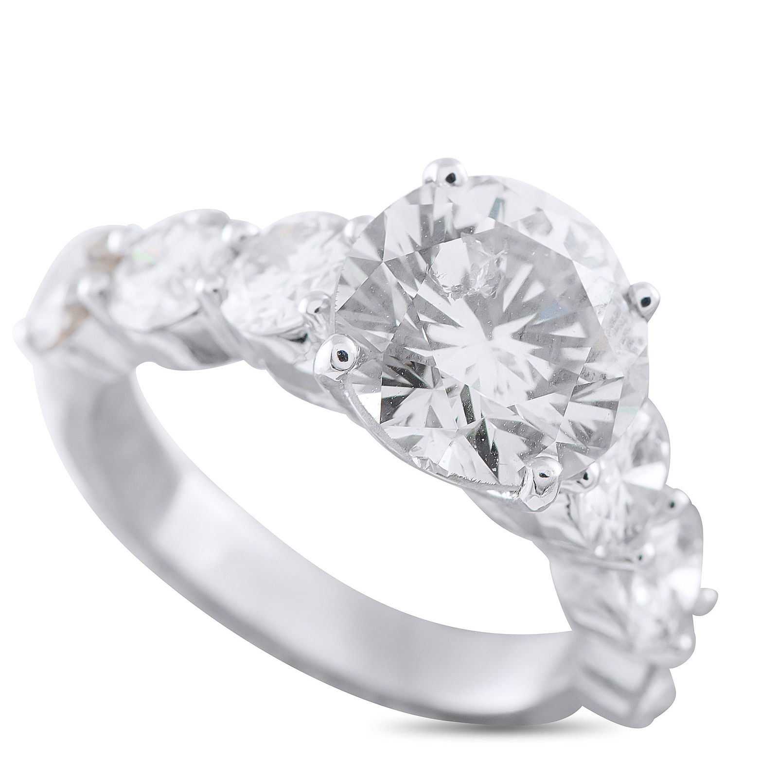 Platinum 5.79ct Diamond Ring: This platinum ring lifts a 3.62-carat M-color, I1-clarity diamond toward the light, held by four prongs. On either side, scalloped trios of diamonds set on shared prongs form a repeating pattern that