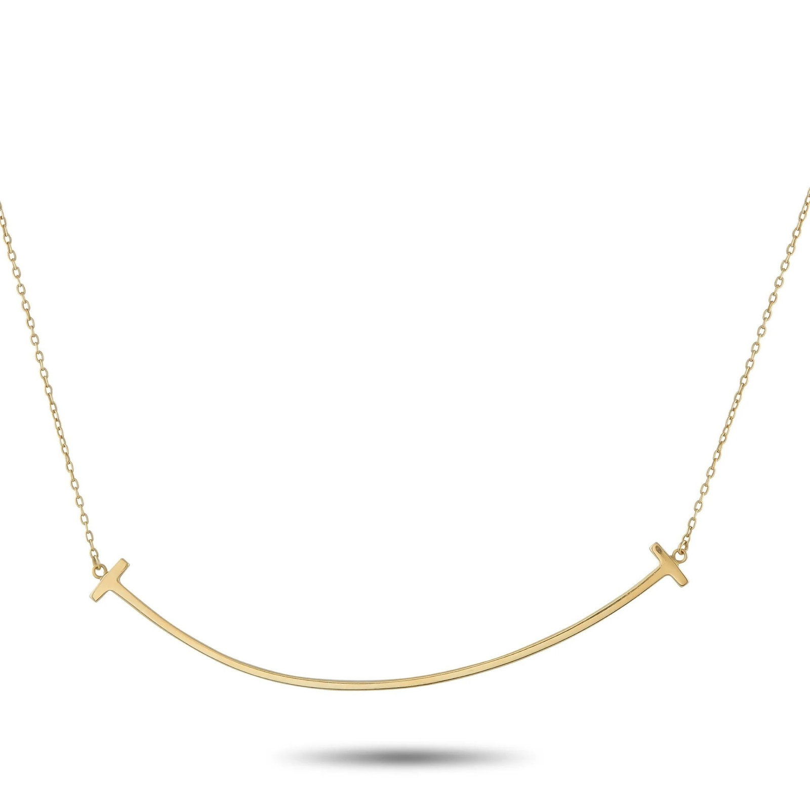 Tiffany & Co. - 18 kt. Yellow gold, Tiffany & Co. 18K Yellow Gold T Smile Necklace: Tiffany & Co. 18K Yellow Gold T Smile NecklaceThis Tiffany & Co. T Smile necklace celebrates the luxury brand’s most iconic motif. Suspended at the center of a 17” chain, a curved T-shaped